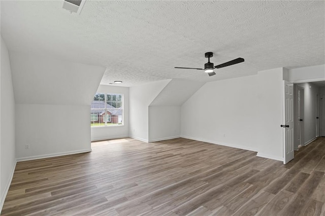 1069 Alford Rd, Lithonia, GA 30058 - additional living space with wood finished floors, a textured ceiling, a ceiling fan, and vaulted ceiling