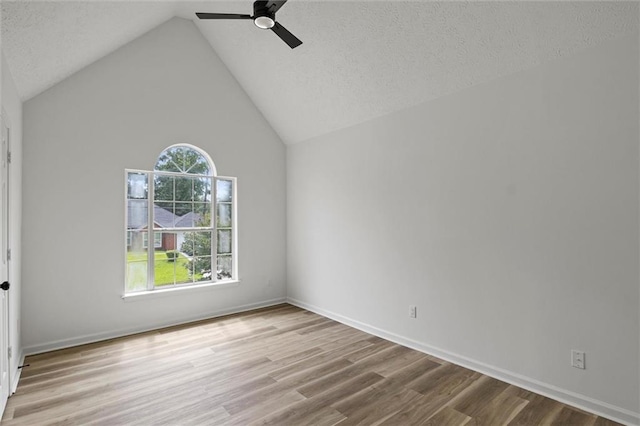 1069 Alford Rd, Lithonia, GA 30058 - unfurnished room featuring wood finished floors, ceiling fan, vaulted ceiling, and a textured ceiling