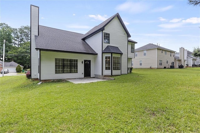 1069 Alford Rd, Lithonia, GA 30058 - back of house featuring a patio, a lawn, a shingled roof, and a chimney