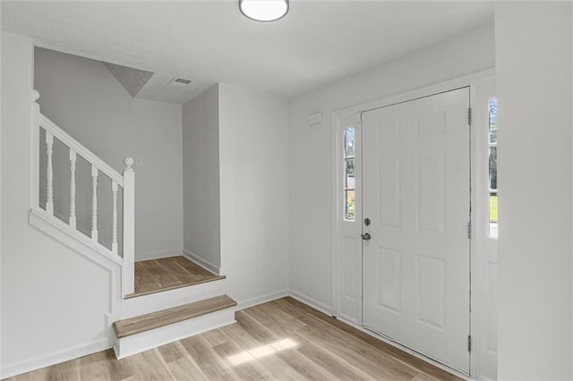 1069 Alford Rd, Lithonia, GA 30058 - entrance foyer featuring stairway, healthy amount of natural light, and wood finished floors