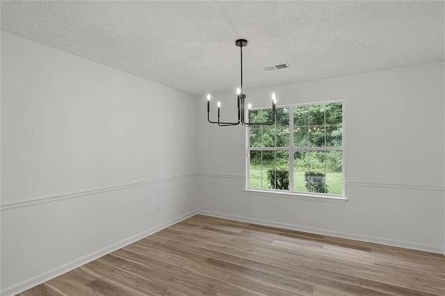 1069 Alford Rd, Lithonia, GA 30058 - empty room featuring a chandelier, a textured ceiling, and wood finished floors