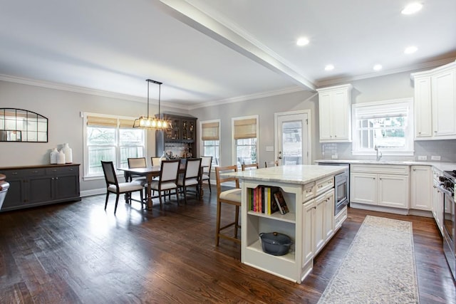 kitchen with a healthy amount of sunlight, dark wood finished floors, backsplash, and open shelves