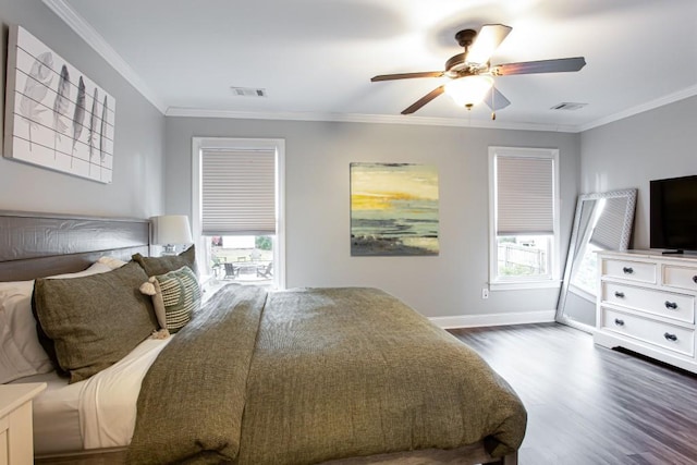 bedroom featuring ornamental molding, visible vents, dark wood finished floors, and multiple windows