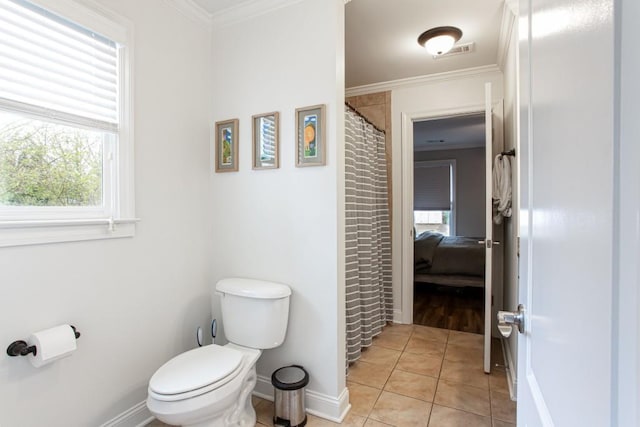 bathroom featuring toilet, visible vents, baseboards, ornamental molding, and tile patterned floors