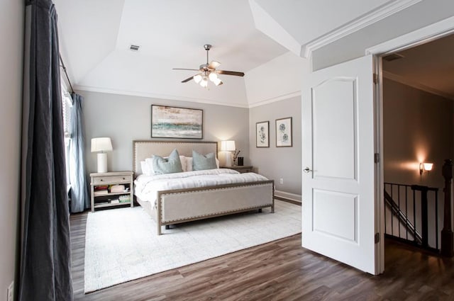 bedroom featuring lofted ceiling, dark wood-style flooring, and crown molding