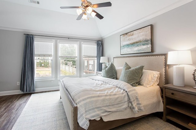 bedroom featuring ornamental molding, vaulted ceiling, ceiling fan, wood finished floors, and baseboards