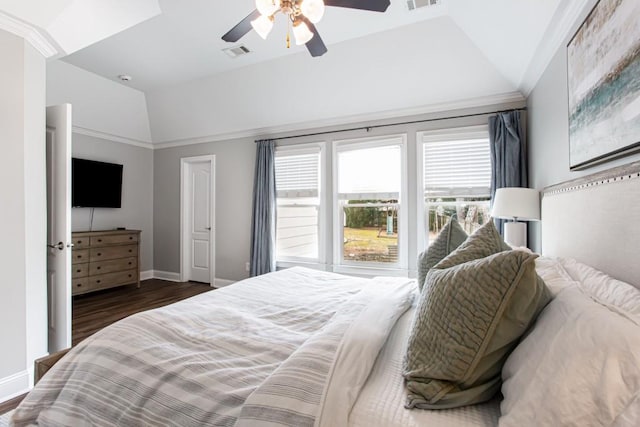 bedroom featuring baseboards, visible vents, vaulted ceiling, and wood finished floors