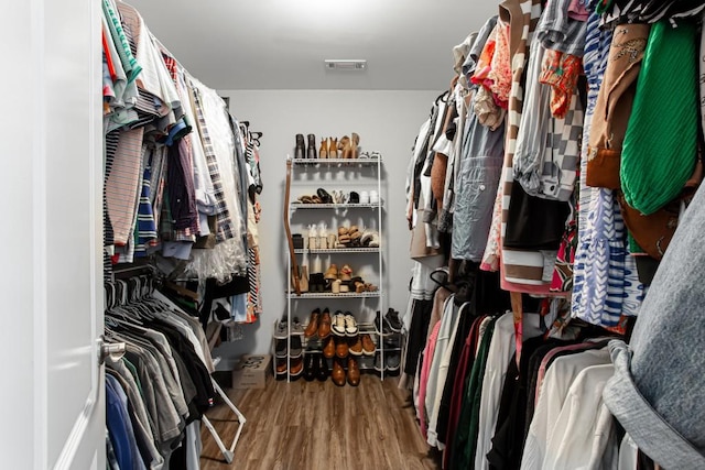 spacious closet featuring visible vents and wood finished floors