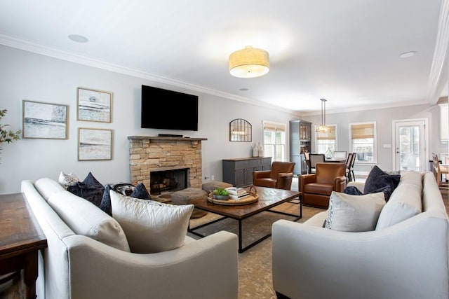 living area with ornamental molding and a fireplace