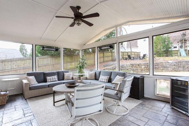 sunroom / solarium featuring a ceiling fan, wine cooler, and vaulted ceiling