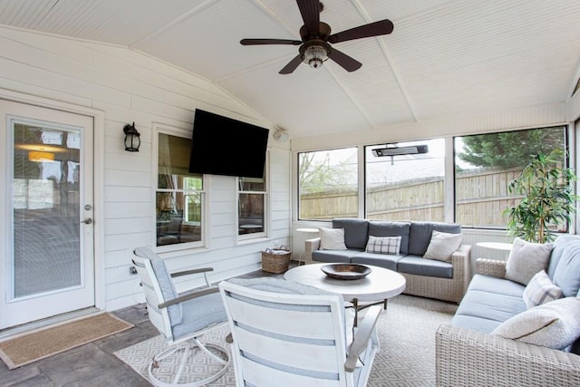 sunroom featuring lofted ceiling and ceiling fan