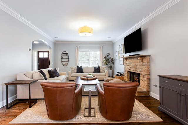 living area with arched walkways, dark wood-style flooring, crown molding, and baseboards