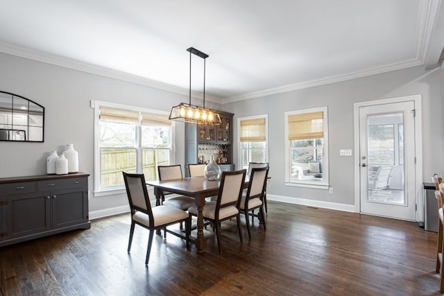 dining space featuring ornamental molding, dark wood-type flooring, and baseboards