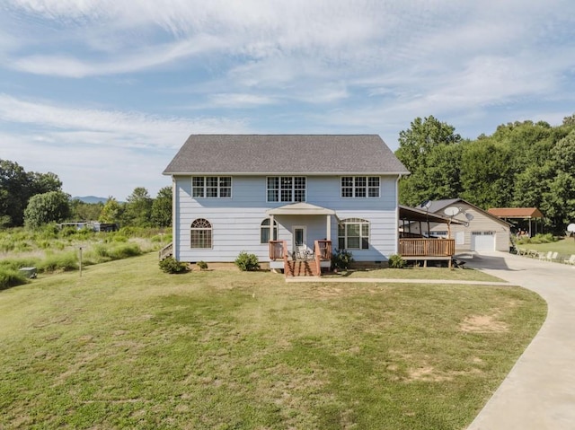 view of front of home featuring an outbuilding, a deck, and a front lawn