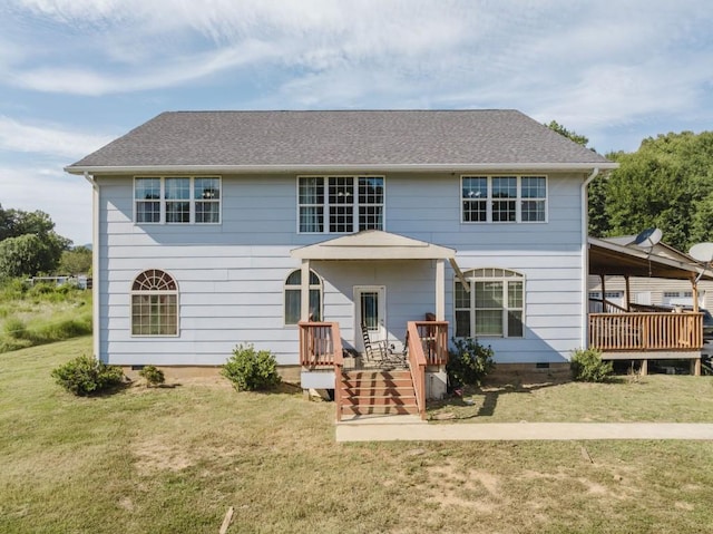 rear view of property featuring a lawn