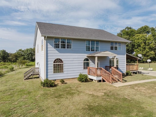 view of front of home with a wooden deck and a front lawn