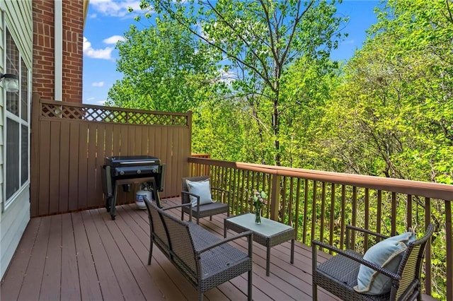 wooden deck featuring a grill