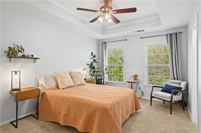 bedroom with ornamental molding, baseboards, a raised ceiling, and light carpet