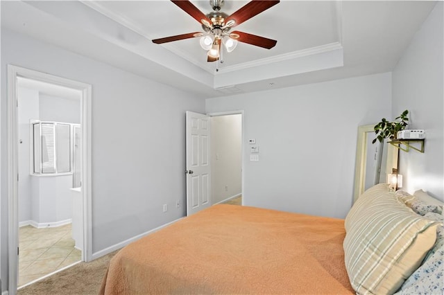 bedroom with crown molding, ceiling fan, ensuite bathroom, light colored carpet, and a raised ceiling