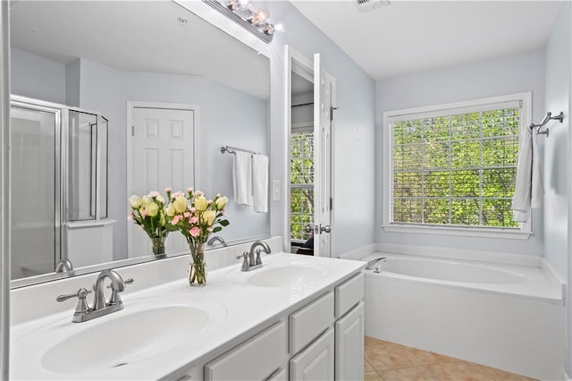 full bath with tile patterned flooring, a bath, a sink, and a stall shower