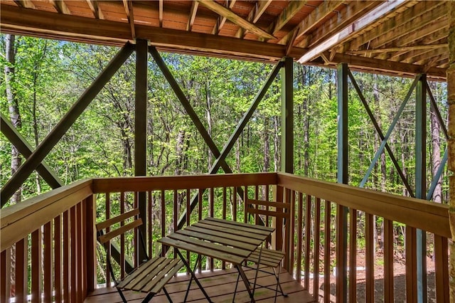 wooden terrace featuring a forest view