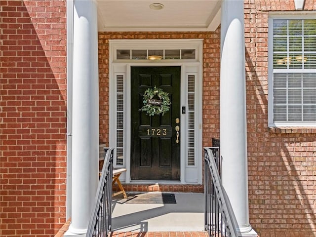 property entrance featuring brick siding
