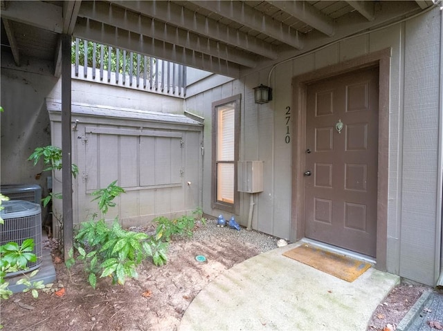 property entrance with central AC unit