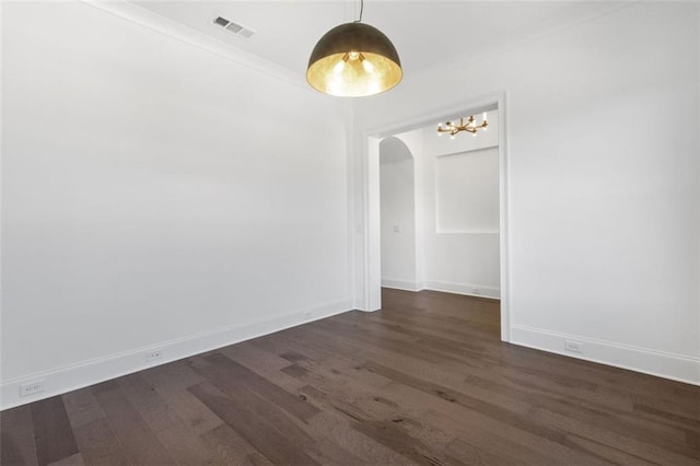 empty room with crown molding and dark hardwood / wood-style floors