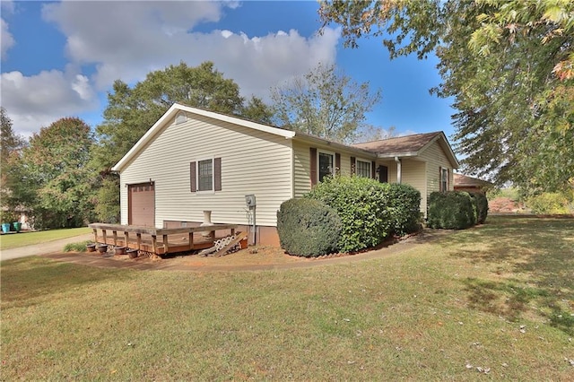 view of side of property with a garage and a yard