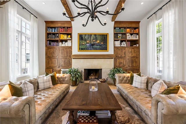 11277 Serenbe Ln, Chattahoochee Hills, GA 30268 - living area with built in shelves, a chandelier, a premium fireplace, beam ceiling, and recessed lighting