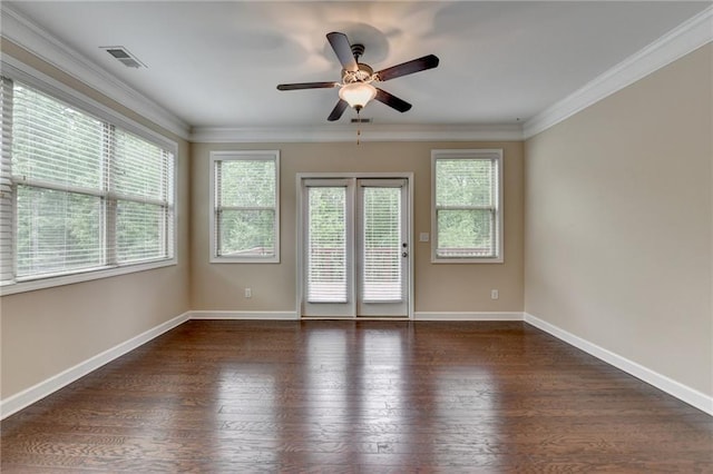 empty room featuring wood finished floors, plenty of natural light, ceiling fan, and visible vents