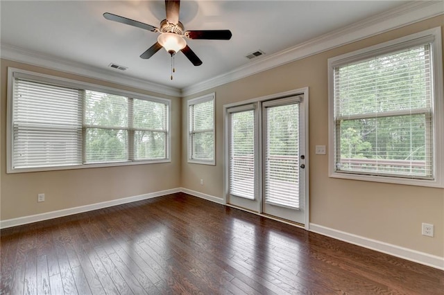 spare room with baseboards, dark wood-style floors, and visible vents