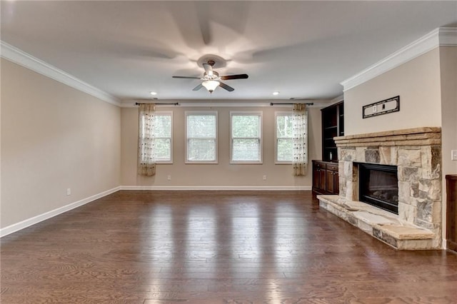 unfurnished living room featuring a healthy amount of sunlight, crown molding, a ceiling fan, and dark wood-type flooring