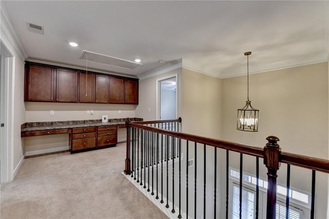 hall featuring light colored carpet, attic access, crown molding, and visible vents