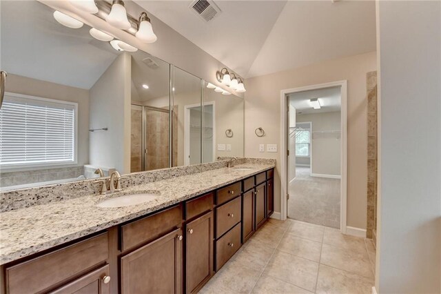 full bathroom with visible vents, a shower stall, a sink, and lofted ceiling