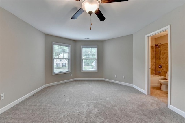 empty room featuring baseboards, a ceiling fan, and carpet