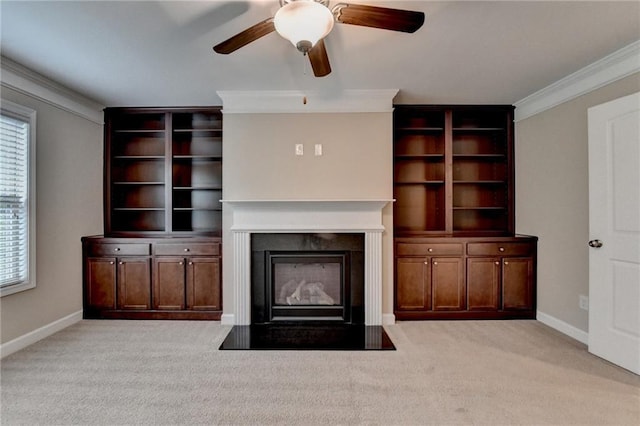 unfurnished living room with a fireplace with flush hearth, ornamental molding, ceiling fan, and a wealth of natural light