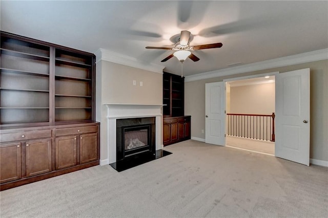 unfurnished living room with ornamental molding, light carpet, a fireplace, baseboards, and a ceiling fan