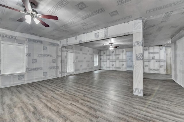 interior space with a ceiling fan and wood finished floors