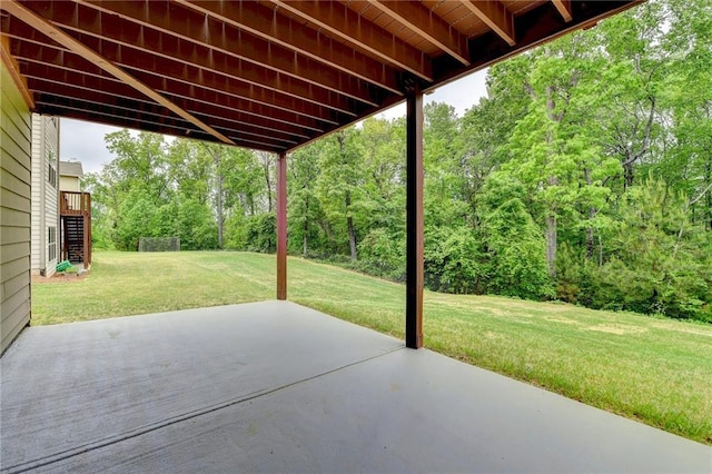 view of patio featuring a view of trees and stairs
