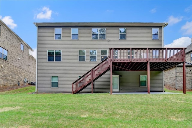 back of house with a lawn, stairway, and a deck