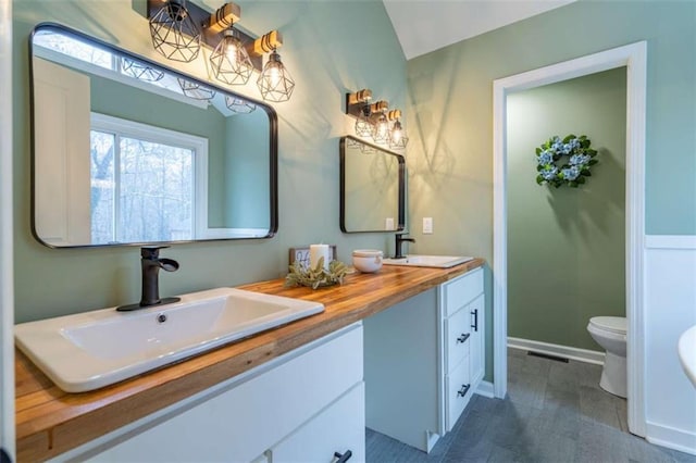 9 Woodberry Dr SE, Silver Creek, GA 30173 - bathroom featuring double vanity, toilet, and baseboards