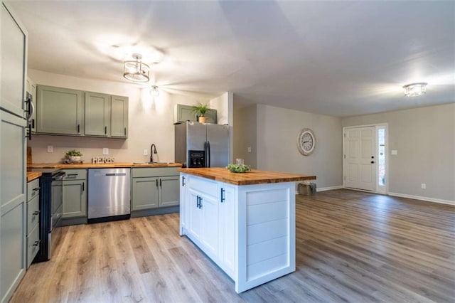 9 Woodberry Dr SE, Silver Creek, GA 30173 - kitchen featuring butcher block counters, appliances with stainless steel finishes, a sink, light wood-style floors, and baseboards