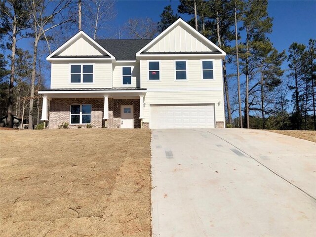 craftsman house with a front lawn and a garage