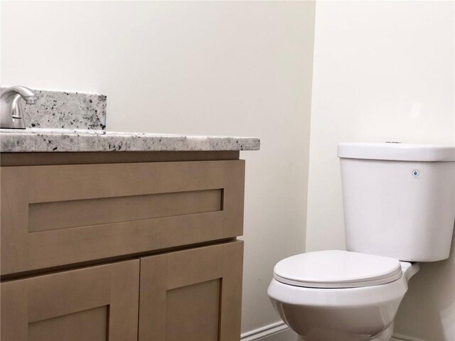 bathroom featuring toilet and vanity