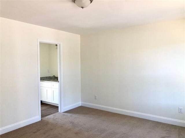 unfurnished bedroom with recessed lighting, a raised ceiling, light colored carpet, and baseboards