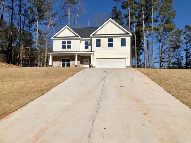 view of front of home with board and batten siding, driveway, and an attached garage