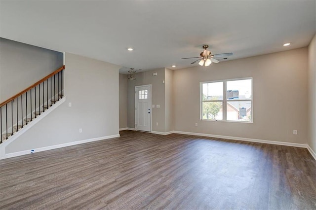 unfurnished living room with ceiling fan and dark wood-type flooring