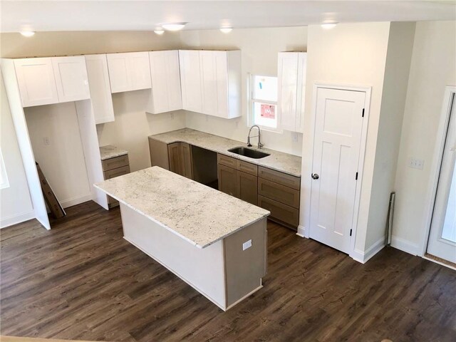 kitchen with gray cabinets, appliances with stainless steel finishes, light stone counters, white cabinets, and sink