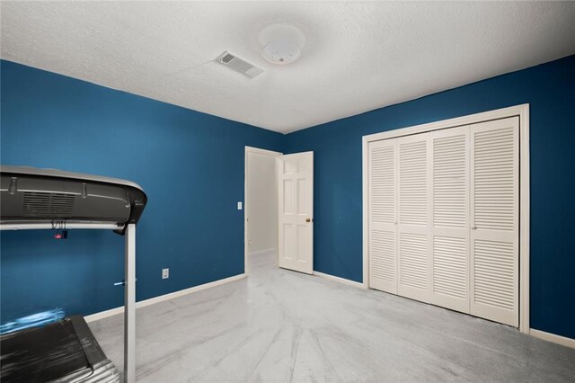 interior space featuring a textured ceiling and light carpet